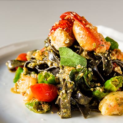 Ocean wise™ Canadian lobster and prawns, pistachio green chili pesto, squid ink tagliatelle. 