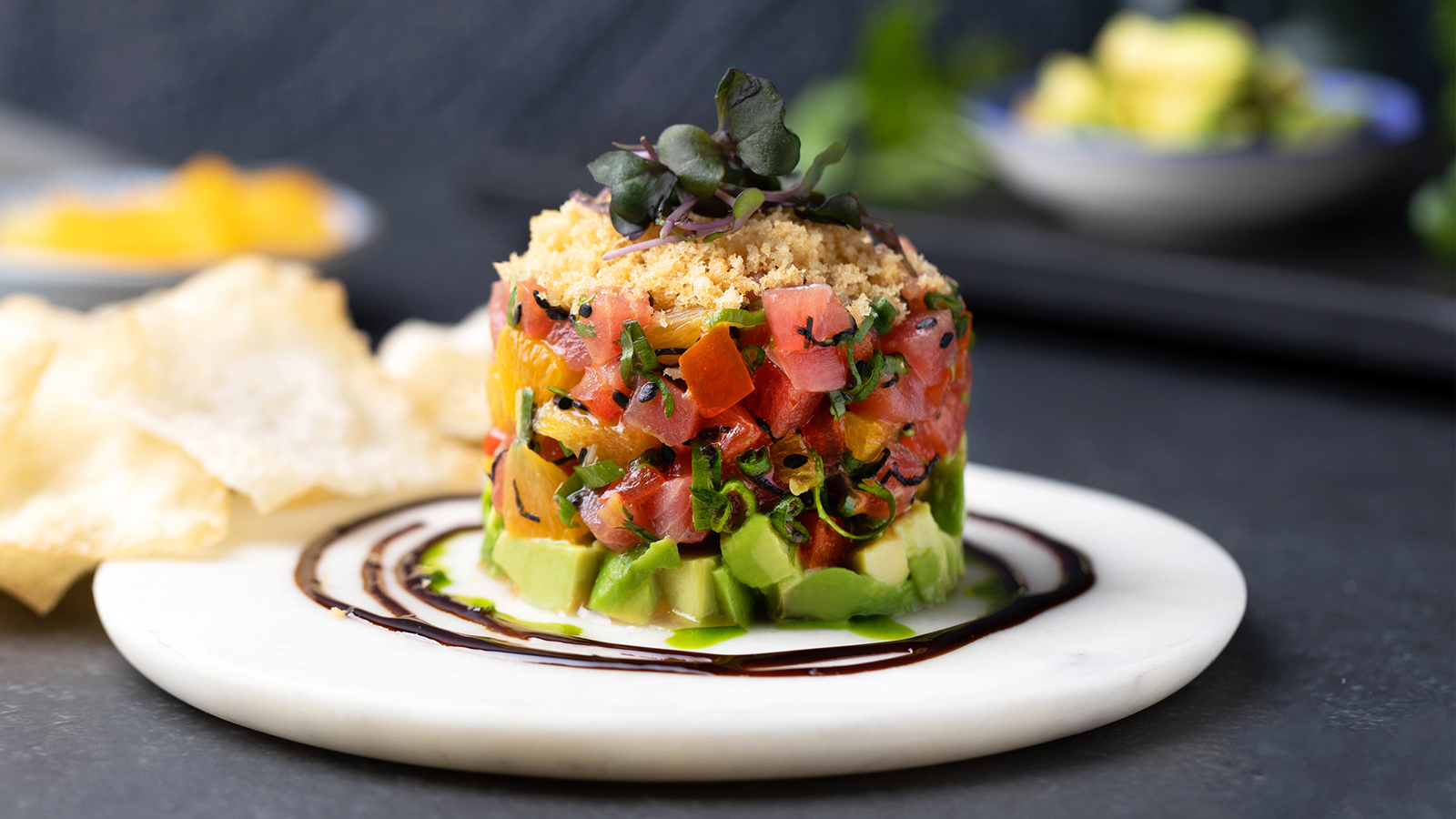 Tuna Stack - created by chef rob feenie. ocean wise™ ahi, citrus tamari vinaigrette, nori, sesame, avocado, micro greens, wonton crisps.